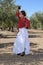 Girl in a flamenco position in an olive grove
