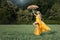 Girl flies over the field. In his hand umbrella.