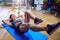 Girl on floor doing exercises on the stomach in the gym. Wet b