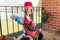 Girl with flowerpot replant flower of african violet