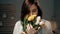 Girl with flowers, attractive young woman holding bouquet of yellow tulips and sniffs flowers. International Womens Day,