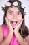 Girl with flowers on head and look amazed
