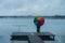 Girl in the fog on the pier with a rainbow umbrella