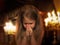 Girl folded her hands in a prayerful gesture. Child praying in the temple