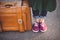 Girl foots in gumshoes with travel bag