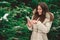 Girl in forest touching phone