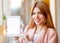 Girl freelancer holding a tablet in the office