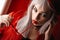 Girl Frenchwoman in a red beret with red glasses heart with big beautiful eyes in the interior loft studio. Woman in a red jacket