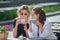 Girl friends in cafe outdoor. Outdoors portrait of two young beautiful women friends drinking coffee. Two beautiful