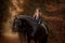 Girl with friesian horse autumn forest