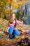 Girl frying marshmallows on fire, trekking in the forest