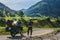 Girl in full body protection, turtle armor, knee pads and helmet, motorcycle for traveling with large luggage, on a background of