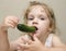 Girl funny eating cucumber