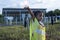 A girl with the future of renewable energy and sustainable energy. holding a light bulb in their hand at the solar panel solar