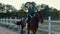 A girl galloping on horseback at outdoor manege