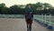 A girl galloping on horseback at outdoor manege