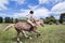 Girl galloping on a Sabino paint horse