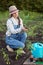 Girl in the garden makes planting seeds