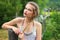 Girl in a garden near a wooden fence