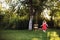 Girl in the garden playing with swings.