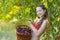 Girl in garden with a sweet cherry basket