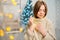 girl with Garland in hands, beautifully decorated New Year