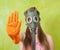 Girl in gas mask pointing STOP