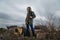 Girl in gas mask standing among ruins and dramatic sky background. Enviromental pollution, ecology disaster, radiation, biologica