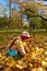 Girl gathering autumn leaves