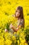 Girl gathers a bouquet of yellow wildflowers
