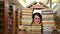 Girl gazing through books