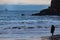 Girl gazing at the rough sea and ferryboat, Tynemouth, UK