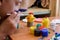 Girl gently paints Easter eggs with a brush and paints