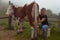 Girl gets natural milk on a farm in the carpathian mountains