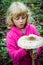 Girl with giant parasol mushroom