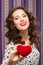 Girl gives heart. Concept of Valentine\'s Day