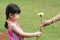 Girl giving carnation to mother.