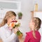 Girl giving flowers to mother