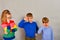 The girl with glasses and her two younger brothers show their respect and love for their sister