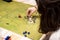 Girl with glasses playing role game dungeons and dragons, miniatures and dices on the green field