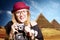 Girl in glasses with retro camera on Egypt pyramid