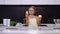 Girl with glasses shows fresh pear and apple in kitchen