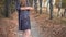 The girl in glasses standing in autumn forest. Panorama from toe to head.