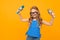 Girl in glasses waves his hands with microphones on an orange background