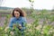 Girl at gloves cleaning ficus plant