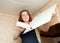 Girl glues ceiling tile