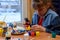 A girl glues a decorative element to a craft with a glue gun