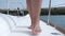Girl goes on the deck of the yacht. Feet of a young girl close-up