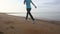 girl goes at jog trot along beach at sunrise