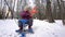 Girl goes through the woods in the winter to Uran and collects snowballs